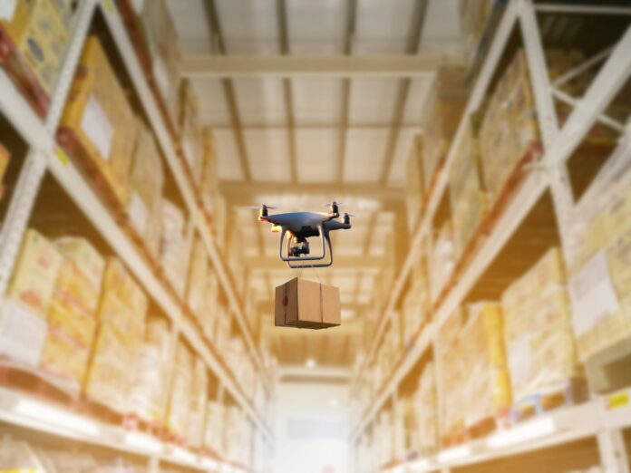 Industrial stock storage products storage system by drone unmanned aircraft Drone scanning industrial warehouse inventory, an example of digital transformation
