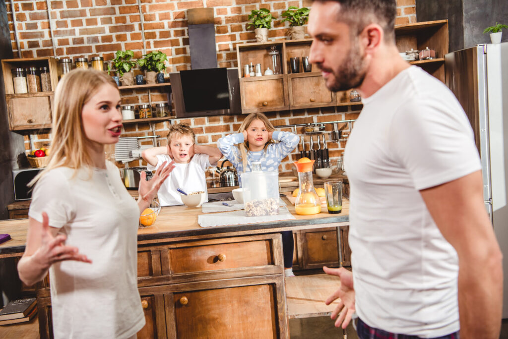 Couple arguing in front of children
