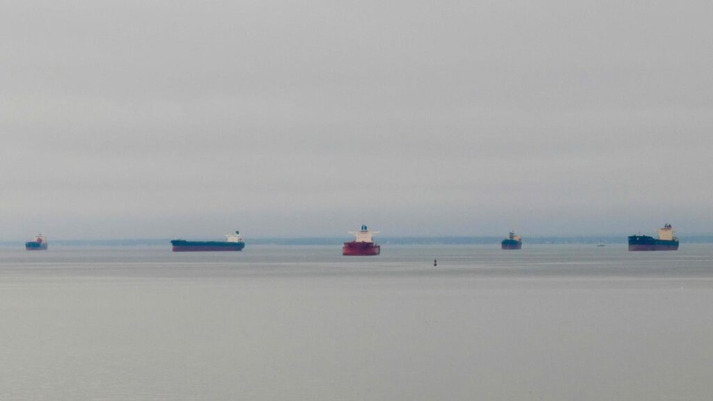 This aerial image shows container ships anchored in the Chesapeake Bay off Annapolis, Maryland, on March 27, 2024, after The Francis Scott Key Bridge in Baltimore collapsed, blocking the entrance to the Port of Baltimore